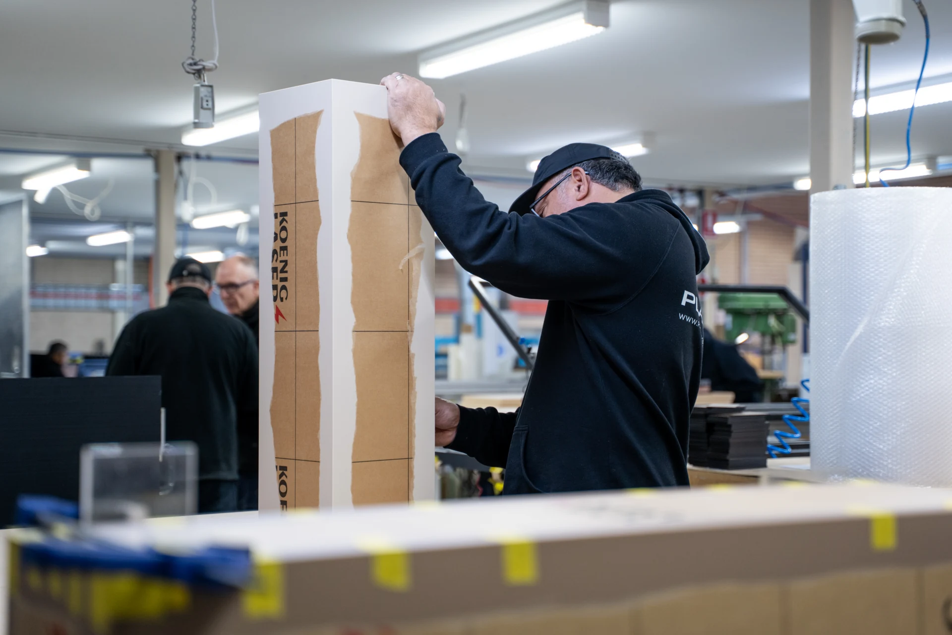 A Plastix team member wrapping a finished panel for dispatch